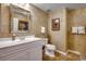 Bathroom with white vanity, textured walls, and a large mirror at 8500 Margate Circle # 2704, Myrtle Beach, SC 29572