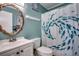 Clean bathroom with a shower/tub combo and a beach-themed shower curtain at 814 N Waccamaw Dr. # 311, Garden City Beach, SC 29576