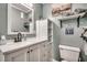 Clean bathroom with white vanity, shower, and ample storage at 814 N Waccamaw Dr. # 311, Garden City Beach, SC 29576