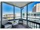 Enjoy the view from this screened balcony, furnished with comfortable wicker chairs at 814 N Waccamaw Dr. # 311, Garden City Beach, SC 29576