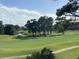 Expansive green golf course with trees and a pond at 4878 Luster Leaf Circle # 404, Myrtle Beach, SC 29577