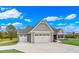 New home exterior with gray siding, double garage and landscaped yard at 550 Wagon Wheel Trail, Calabash, NC 28467