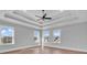 Bright bedroom with hardwood floors, multiple windows, and tray ceiling at 423 West Palms Dr., Myrtle Beach, SC 29579