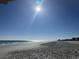 Expansive beach with ocean waves and clear sky; tire tracks on the sand at 700 N Waccamaw Dr. # 319, Garden City Beach, SC 29576