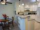Bright kitchen with granite countertops, white cabinets, and a breakfast bar at 700 N Waccamaw Dr. # 319, Garden City Beach, SC 29576