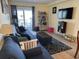 Comfortable living room with sofa, rug, and built-in shelving; access to a balcony at 700 N Waccamaw Dr. # 319, Garden City Beach, SC 29576