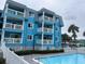 Inviting blue swimming pool with a white fence and surrounding buildings at 700 N Waccamaw Dr. # 319, Garden City Beach, SC 29576