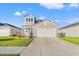 Two-story home with attached garage and landscaping at 1099 Saltgrass Way, Myrtle Beach, SC 29588