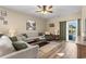 Bright living room features hardwood floors, comfy sofas, and a view to backyard at 1099 Saltgrass Way, Myrtle Beach, SC 29588