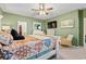Main bedroom with a king-size bed, rocking chair, and large TV at 1099 Saltgrass Way, Myrtle Beach, SC 29588