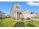 Two-story house with a landscaped lawn and driveway at 1099 Saltgrass Way, Myrtle Beach, SC 29588