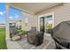 Relaxing covered patio with seating and a grill at 1099 Saltgrass Way, Myrtle Beach, SC 29588
