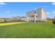 Spacious backyard with a covered patio and grassy lawn at 1099 Saltgrass Way, Myrtle Beach, SC 29588