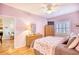 Bedroom with light pink walls, ceiling fan, and access to the bathroom at 5102 Sweetwater Blvd., Murrells Inlet, SC 29576