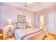 Serene bedroom with light pink walls, a ceiling fan, and en-suite bathroom access at 5102 Sweetwater Blvd., Murrells Inlet, SC 29576