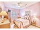 Relaxing bedroom with light pink walls, a ceiling fan, and plenty of natural light at 5102 Sweetwater Blvd., Murrells Inlet, SC 29576
