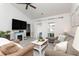 Living room with comfortable seating, large TV, and sliding doors to balcony at 4878 Dahlia Ct. # 24-304, Myrtle Beach, SC 29577