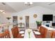 Bright dining area with wood table, chairs, and a view of the kitchen at 4878 Dahlia Ct. # 24-304, Myrtle Beach, SC 29577