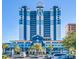 Paradise Resort: Oceanfront high-rise building with blue and white exterior and ample parking at 2201 S Ocean Blvd. # 1404, Myrtle Beach, SC 29577