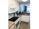 Clean kitchen with granite counters, white cabinets, and modern appliances at 2201 S Ocean Blvd. # 1404, Myrtle Beach, SC 29577