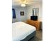 King-size bed, dresser, TV, and ceiling fan in a bright bedroom at 2201 S Ocean Blvd. # 1404, Myrtle Beach, SC 29577