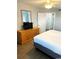 King-size bed, dresser with TV, and access to another room at 2201 S Ocean Blvd. # 1404, Myrtle Beach, SC 29577