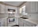 White kitchen with updated flooring and appliances at 3701 South Green Sea Rd., Loris, SC 29569