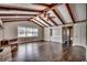Spacious living room with hardwood floors, exposed beams, and a brick fireplace at 3701 South Green Sea Rd., Loris, SC 29569