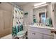 Clean bathroom with a shower/tub combo, white vanity, and coastal-themed decor at 2226 Huntington Dr. # D, Surfside Beach, SC 29575