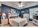 Main bedroom with a king bed, navy walls, and white dresser at 2226 Huntington Dr. # D, Surfside Beach, SC 29575