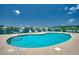 Kidney-shaped community pool with plenty of lounge chairs at 2226 Huntington Dr. # D, Surfside Beach, SC 29575