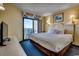 King bedroom with TV and private balcony access at 7100 Ocean Blvd. N # 825, Myrtle Beach, SC 29572