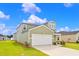 Two-story house with green siding, white garage door, and landscaping at 420 Ribbon Rail Way, Loris, SC 29569