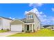 Two-story house with green siding and a white garage door at 420 Ribbon Rail Way, Loris, SC 29569