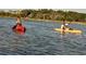 Couple kayaking in calm waters near waterfront homes at 420 Ribbon Rail Way, Loris, SC 29569
