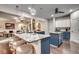 Modern kitchen boasts a large island with seating, blue cabinets, and granite countertops at 713 Shell Point Ct., Longs, SC 29568