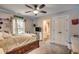 Bright bedroom with a queen bed, en-suite bathroom, and plenty of natural light at 713 Shell Point Ct., Longs, SC 29568