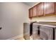 Convenient laundry room with washer, dryer, and upper cabinets at 713 Shell Point Ct., Longs, SC 29568