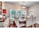 Bright dining room with a rustic farmhouse table and six upholstered chairs at 713 Shell Point Ct., Longs, SC 29568