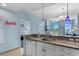 Open kitchen features granite countertops, stainless steel appliances, and a view into the bedroom at 300 N Ocean Blvd. # 128, North Myrtle Beach, SC 29582