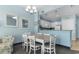 Bright dining area with white table and chairs, and kitchen views at 300 N Ocean Blvd. # 128, North Myrtle Beach, SC 29582