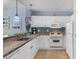 White kitchen with granite countertops and stainless steel appliances at 300 N Ocean Blvd. # 128, North Myrtle Beach, SC 29582