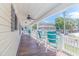 Relaxing front porch with teal chairs and ceiling fan at 6001 - 8016 S Kings Hwy., Myrtle Beach, SC 29575