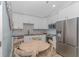 Modern kitchen with white cabinets, stainless steel appliances, and round table at 6001 - 8016 S Kings Hwy., Myrtle Beach, SC 29575