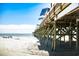 Beach pier extending over ocean with people on the beach at 301 N Waccamaw Dr. # 206, Murrells Inlet, SC 29576