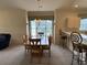 Bright dining area with table and chairs, and access to kitchen at 4893 Magnolia Pointe Ln. # 305, Myrtle Beach, SC 29577