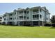 Green three-story building with balconies at 4893 Magnolia Pointe Ln. # 305, Myrtle Beach, SC 29577