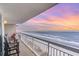 Balcony overlooking the ocean with sunset view and seating at 1625 S Ocean Blvd. # 1002, North Myrtle Beach, SC 29582