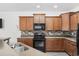 Modern kitchen with dark wood cabinets and granite countertops at 656 Pistoia Ln. # 304, Myrtle Beach, SC 29579