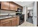 Condo kitchen with dark wood cabinets and black appliances at 1105 S Ocean Blvd. # 106, Myrtle Beach, SC 29577